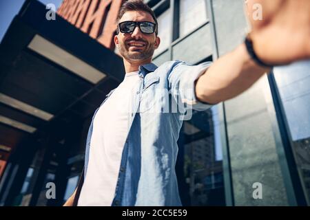 Close up of handsome man that welcoming his friend Stock Photo