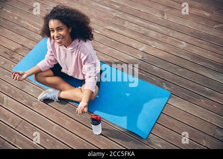 Woman with curly hair relaxing in quiet atmosphere Stock Photo
