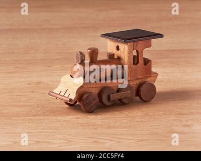 wooden hand-crafted locomotive toy on wooden table Stock Photo
