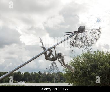 Wire sculptured fairy art work on giant dandelion  by Robin Wight on display at Trentham Gardens Staffordshire England UK. Stock Photo