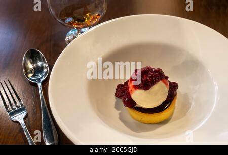 Chocolate tarts with raspberry sauce and a brandy Stock Photo