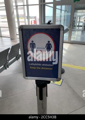 Social distancing sign at Vilnius airport. Passengers have to keep 1-2 meters distance to protect from corona virus spreading. Vilnius / Lithuania.
