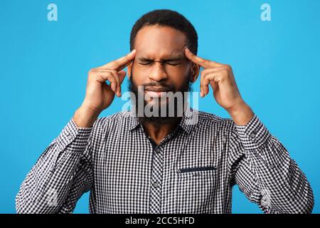 Pensive afro man portrait on blue background Stock Photo