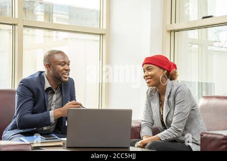 Young black businessman and woman discussing business Stock Photo