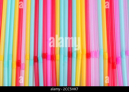 blue, pink and yellow straws for cocktails and other drinks isolated on white background Stock Photo