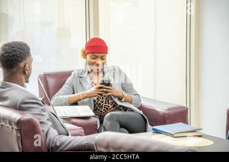 Young black businesswoman using her mobile phone Stock Photo