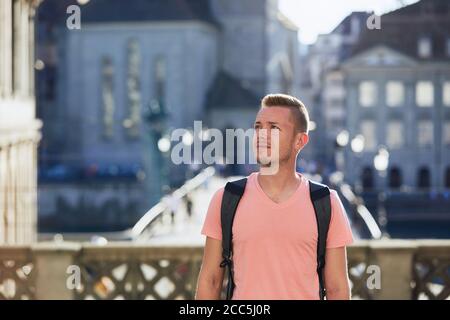 Portrait of young tourist. Young man walking at street of old town. Zurich, Switzerland. Stock Photo
