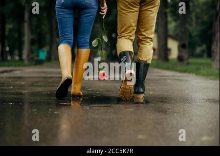 Love couple walks in park, summer rainy day Stock Photo