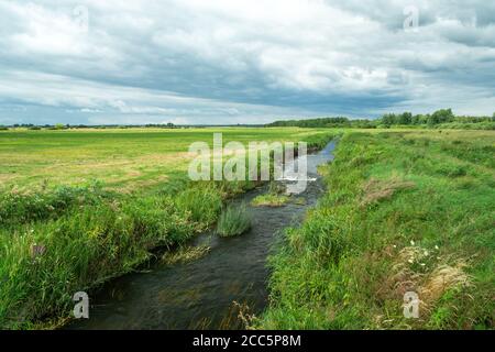 The small river Uherka in eastern Poland flowing through meadows Stock Photo