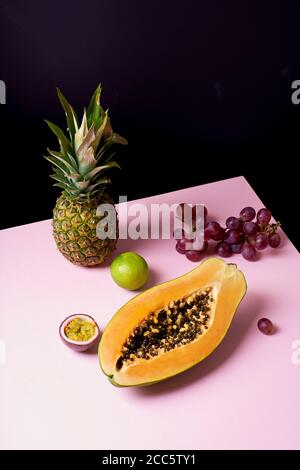 Tropical fruits still life with mango, papaya, pitahaya, passion fruit, grapes, lime and pineapple. Fruit plate Stock Photo