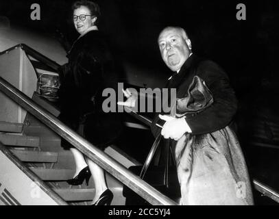 Film director Alfred Hitchcock boarding a plane as he  leaves Rome from Ciampino airport with his wife, Alma Reville, 1960  File Reference # 34000-277THA Stock Photo