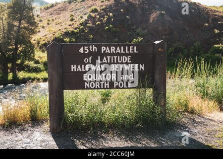 Sign - 45th Parallel of Latitude Halfway between Equator and North Pole sign in the North Entrance of Yellowstone National Park Wyoming Stock Photo