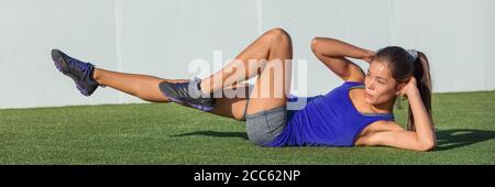 Exercise fitness woman training abs sit up banner on grass home garden. Asian girl doing bicycle crunch workout to train body core. Bodyweight floor Stock Photo