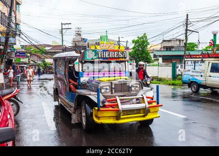 MANILA, PHILIPPINES - FEBRUARY 25, 2013: Jeepneys are popular public transport in the Philippines, they made from old US military jeeps Stock Photo