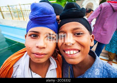 AMRITSAR, INDIA - OCTOBER 07, 2013: Two unideintified sikh boys in turbans posing near Golden Temple in Amritsar, Punjab state of India Stock Photo