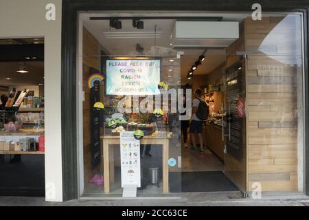 Graz, Austria.  August 2020. A shop window with a sign against Covid-19, racism, sexism and homophobia Stock Photo