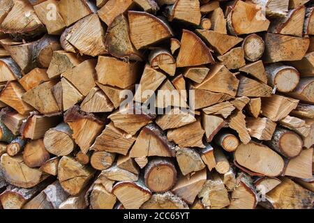 Pile of stacked firewood stored for winter heating, close-up Stock Photo