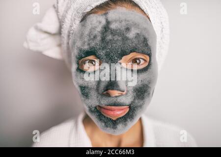 Korean black facial bubble foam face mask charcoal detox bubbles treatment at home -asian girl purifying skin removing dead skin cells with chemical Stock Photo
