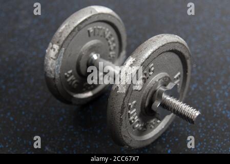 Dumbbell on the floor of a home garage gym Stock Photo