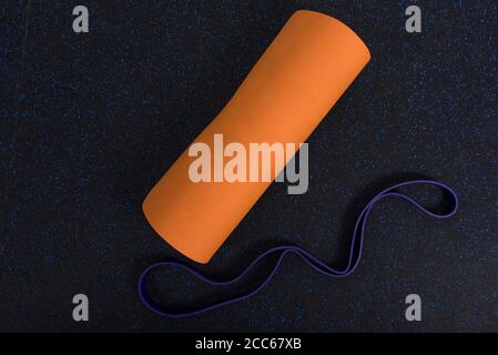 Yoga matt on a home gym flooring with resistance bands Stock Photo