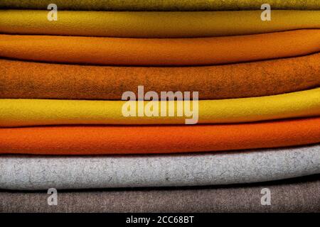stacked felts in yellow and orange tones plus gray and brownish Stock Photo