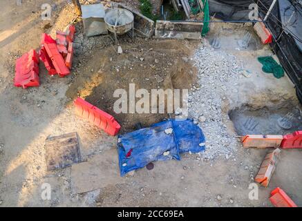 Group of the plastic barriers for protecting the groundwork is under construction the pillar of the bridge in the urban area. Stock Photo