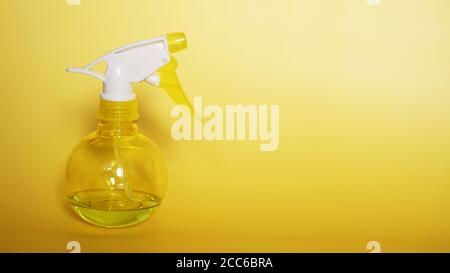 Spray bottle on yellow background. Portable pressure water sprayer pump. Sprayer bottle. Stock Photo
