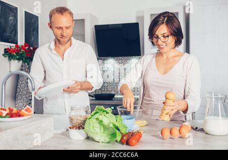 Family moments concept image - married prepare meal together Stock Photo