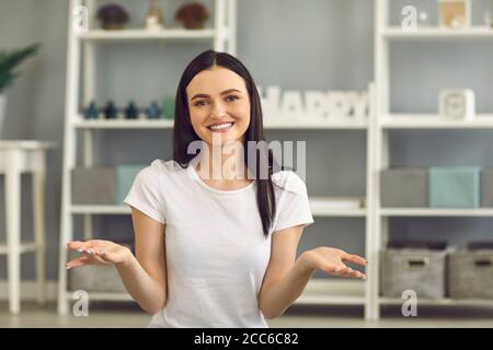 Online communication. Young woman looking at camera and having conversation with friends, family, teacher or boss Stock Photo