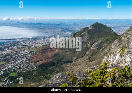 View from Table Mountain of Devil's Peak with sea fog over harbour, Cape Town, South Africa Stock Photo