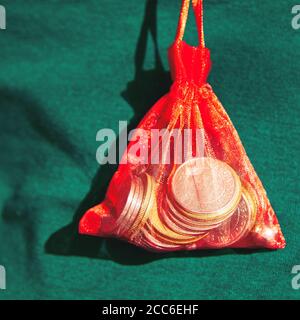 Money collected for hard time . Coin red bag Stock Photo