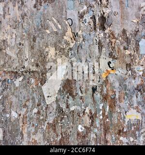 Torn bulletin board with scraps of posters. Grunge background Stock Photo
