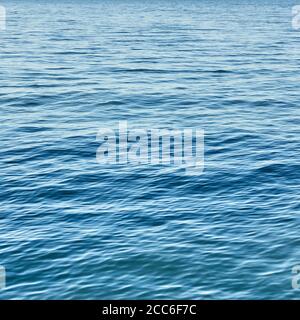 Rippled sea water surface. Natural blue background. The water a bit blurred by motion Stock Photo