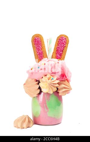 Easter freak shake decorated with Easter with bunny ears cookies isolated on white background Stock Photo