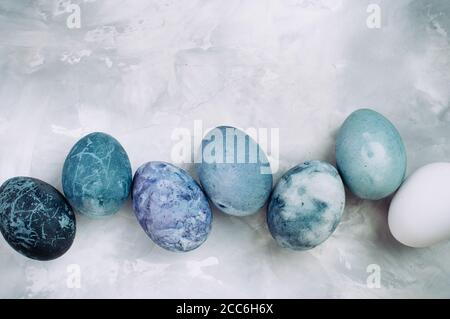 Eggs with marble stone effect on grey concrete background with copy space Stock Photo