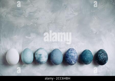 Eggs with marble stone effect on grey concrete background with copy space Stock Photo