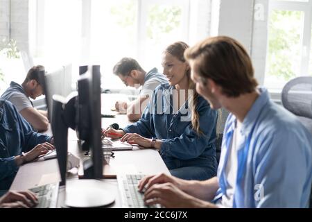 Team Working At Desks In Busy Office. Stock Photo