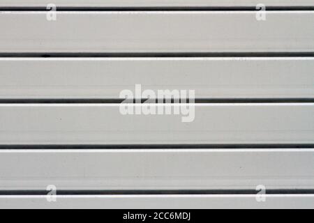 Light white curtain backdrop close-up modern plastic shutter blinds in office room home plastic panels texture background. Stock Photo