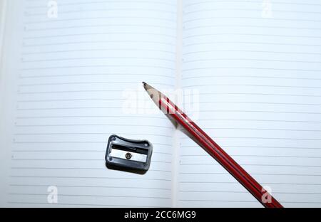 pencils on white notebook paper with Pencil sharpeners Stock Photo