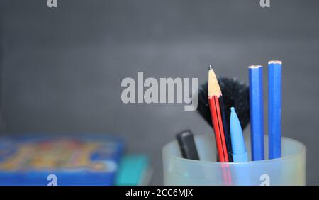 Banner of Shopping cart with school supply in front of blackboard. Back to school concepts Stock Photo