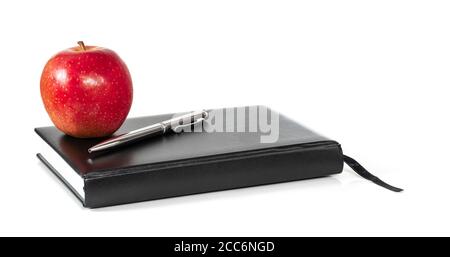 Red apple, book and pen isolated on white background. Healthy lifestyle at school concept. Stock Photo