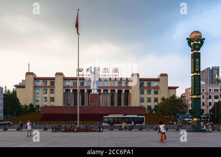 Chengdu, China - August 15,  2015 -Tourists at Tianfu Square in front of the statue of Chairman Mao and the Sichuan Science and Technology Museum in C Stock Photo