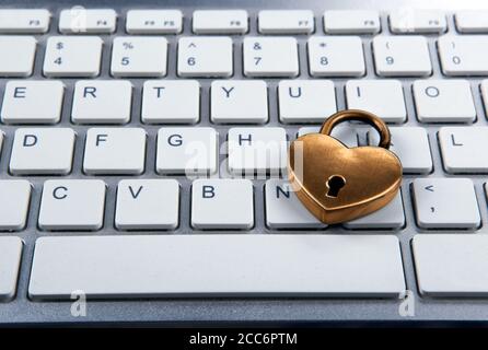 golden padlock on computer keyboard closeup Stock Photo