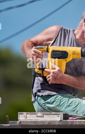 older man doing heavy work Stock Photo