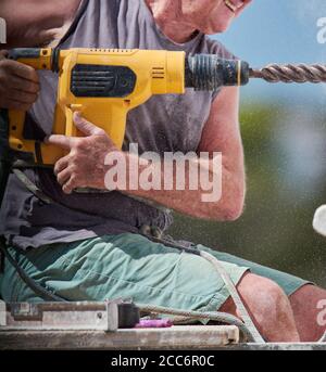 older man doing heavy work Stock Photo