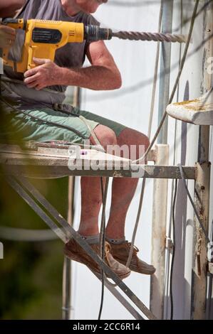 older man doing heavy work Stock Photo