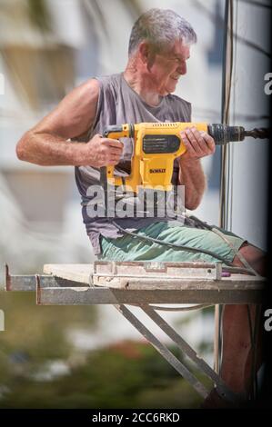 older man doing heavy work Stock Photo