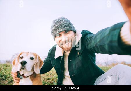 Man takes selfie photo with his best freind beagle dog Stock Photo