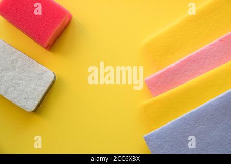 multicolored cleaning micro fiber cloth and cleaning sponges isolated on yellow background. Home cleanliness, Household concept.Colorful sponges on a Stock Photo