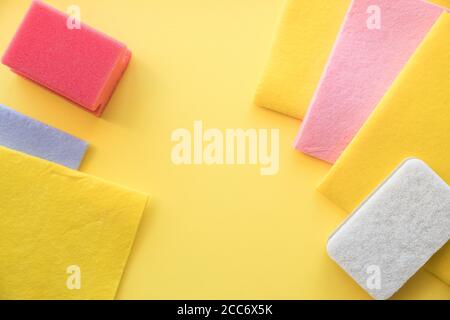 multicolored cleaning micro fiber cloth and cleaning sponges isolated on yellow background. Home cleanliness, Household concept.Colorful sponges on a Stock Photo